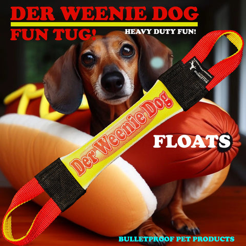 A Dachshund sits behind the Der Weenie Dog Fire Hose Training Mini Tug by Bulletproof Pet Products Inc—a durable, floating tug toy designed for dachshunds.