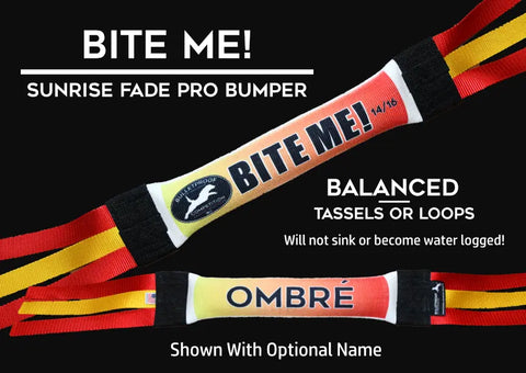 The Bulletproof Pet Products Inc Dock Diving Bumper Tug - Competition Series Weighted - Bite Me Ombre Sunrise Fade features red, yellow, and black straps with “BITE ME!” and “OMBRÉ” labels, balanced tassels/loops, and an optional custom name.