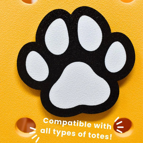 The FRESHe BAGLETS Dog Paw Charm by Chatelet Manufacturing is a cute black and white accessory for Bogg Bags, Simply Southern, and other totes with holes. Made in the USA. Compatible with all types of totes!.