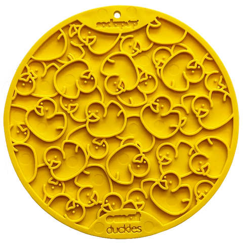 The Duckies Design EMat Enrichment Lick Mat With Suction Cups by SodaPup is a round, yellow silicone mat embossed with overlapping duck shapes—ideal for keeping your dog occupied during bath time.