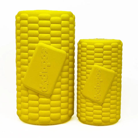 Two yellow, corn-textured cylindrical containers, SodaPups Corn on the Cob EDispenser Durable Rubber Treat Dispenser, feature a diagonal rectangular label and are shown side by side on a white background.