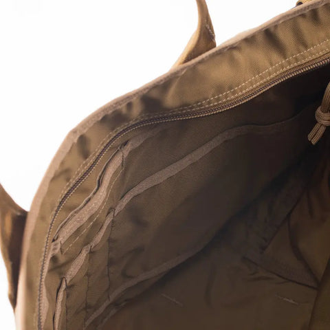 Close-up of the MIS Tote Bag - Coyote Brown, highlighting organized inner pockets and a heavy-duty zipper compartment, all set against a white background.