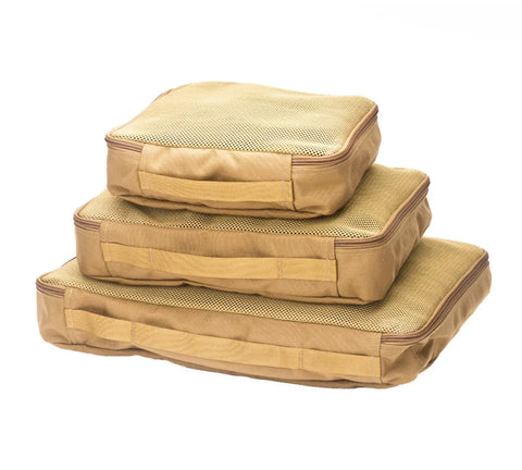 Three coyote brown MIS Organizer Set packing cubes of varying sizes are stacked atop one another, featuring mesh tops and fabric handles, displayed against a white background.