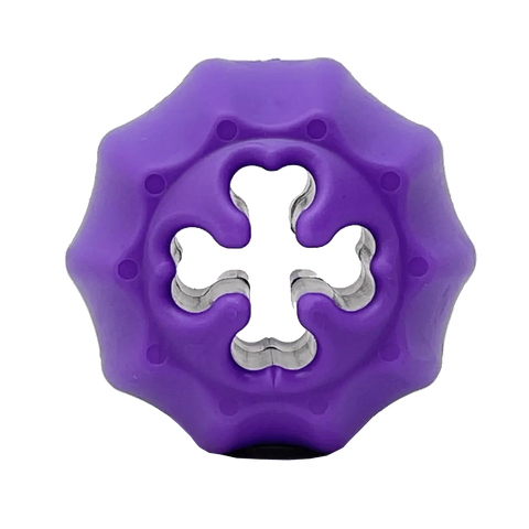 The SodaPup Cross Bones Chew Toy and Treat Pocket is a purple, round, ridged dog toy with a cross-shaped center cutout that dispenses treats, shown on a plain background.