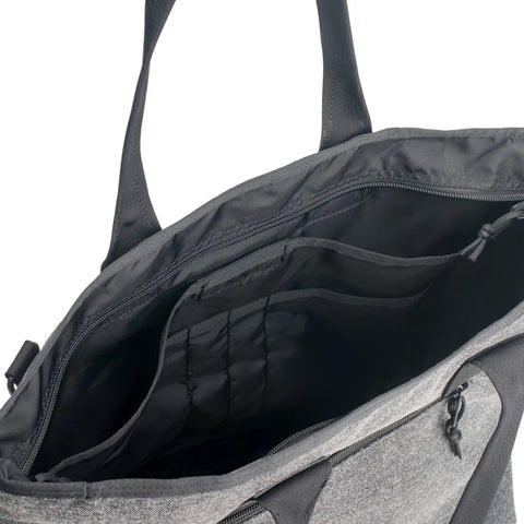 A close-up of the MIS Tote Bag - Denim Grey, made in the USA from water-resistant Cordura nylon, shows multiple interior pockets, compartments, and a zippered section for organized storage.