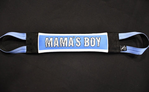 The Mamas Boy Fire Hose Training Tug by Bulletproof Pet Products Inc is a heavy-duty blue and white padded dog toy with black ends and bold MAMAS BOY text, shown on a black background.