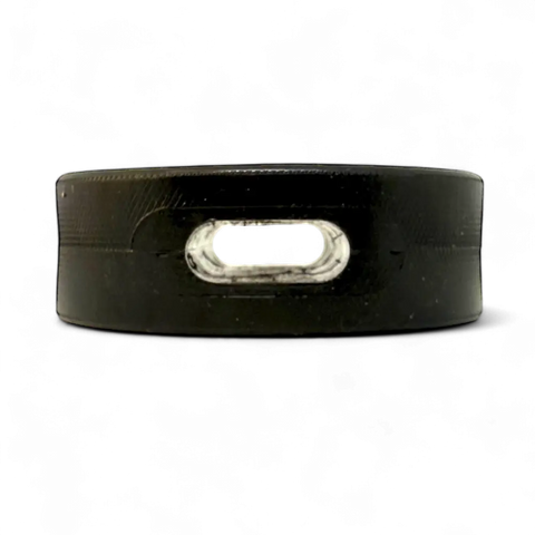 The SodaPup Hockey Puck Durable PUP-X Rubber Treat Holder and Chew Toy, featuring an oval-shaped hole for bully sticks, is displayed against a solid black background.