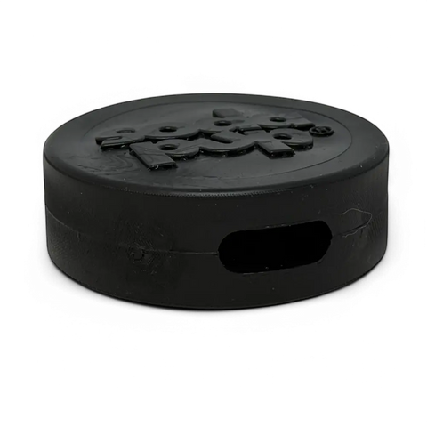 The SodaPup Hockey Puck Durable PUP-X Rubber Treat Holder and Chew Toy is shown in black with Puck embossed on top and a side cutout, ideal as a tough chew toy and bully stick holder for playful dogs.