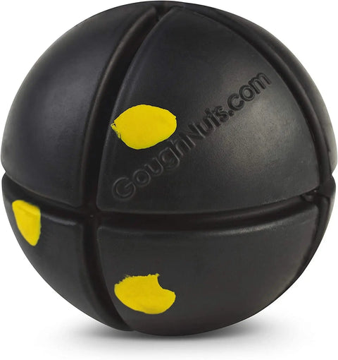 The Goughnuts Interactive Black 50 - Toughest Ball is a durable black rubber dog toy with yellow spots and deep grooves, designed for tough play and embossed with “GoughNuts.com” on its surface.