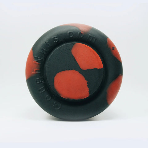 The Goughnuts K9 Kup, a round black rubber dog toy with red patches and GoughNuts.com embossed on the edge, is designed for durability and shown on a plain white background.
