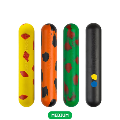 Four Goughnuts Medium Stick chew toys for dogs 30–70 lbs stand upright in a row. Colors include yellow with red spots, orange with black spots, green with red spots, and black with blue/yellow dots. MEDIUM label shown below.
