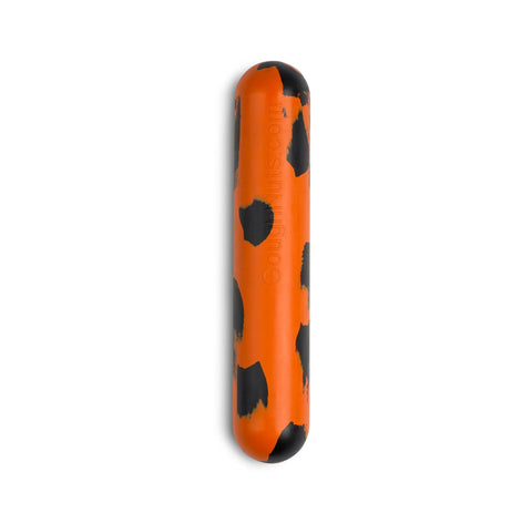 The Goughnuts Medium Stick, designed for dogs 30–70 pounds, is an orange, indestructible cylindrical toy with bold black spots and a stick-like shape, perfect for medium breeds and pictured on a white background.