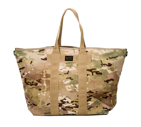 The MIS Super Tote Bag - Multi Cam is a 40L water-resistant duffel with tan handles and a black MIS patch, made in the USA from durable Cordura nylon—ideal for outdoor or travel use.