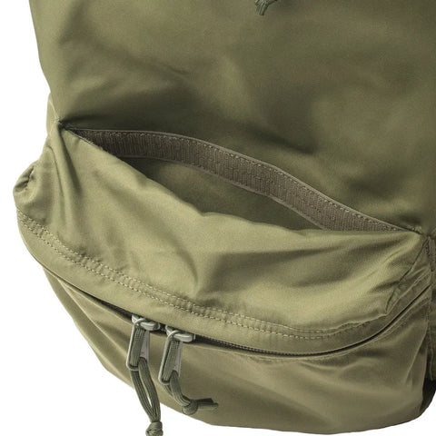 Close-up of the MIS Daypack - Olive Drab, highlighting the open front zip pocket with dual pull tabs and revealing its water-resistant nylon lining.