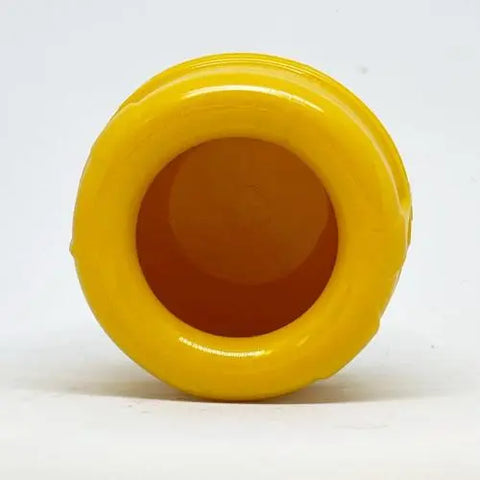 The SodaPup Honey Pot Durable PUP-X Rubber ECup Treat Dispenser & Enrichment Toy is shown from the bottom against a white background, highlighting its yellow color, round shape, and smooth circular base.