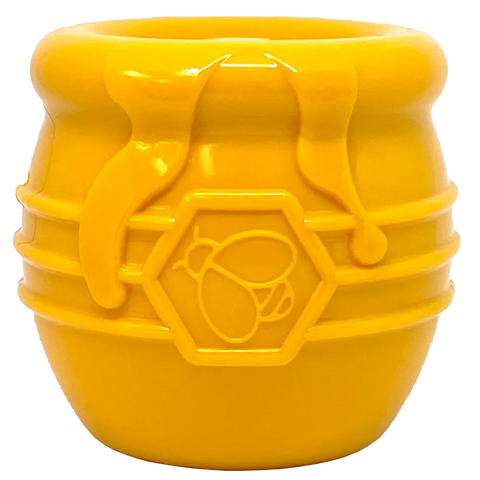 The SodaPup Honey Pot Durable PUP-X Rubber ECup Treat Dispenser & Enrichment Toy is a small, yellow, barrel-shaped toy with honey drips and a bee emblem, designed to resemble a classic honey pot.