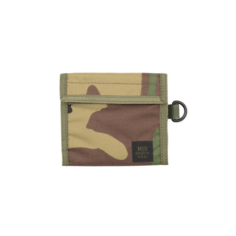 The MIS Folding Wallet - Woodland Camo is a nylon wallet in green, brown, and tan with a small black MIS Made in U.S.A. label, metal D-ring on one side, and a convenient coin pocket for extra storage.