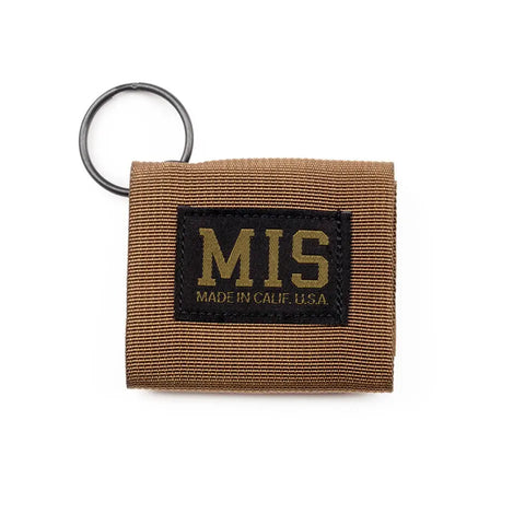 The MIS Duty Key Silencer in Coyote Brown is a durable nylon webbing keychain wallet with Velcro closure, black ring, and a black patch displaying MIS MADE IN CALIF. U.S.A. in yellow letters.