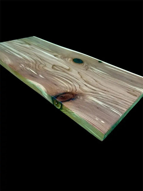 The B. James Design & Woodwork Eastern Red Cedar Live Edge Charcuterie Board showcases handcrafted quality, natural grain, and knots with smooth edges and a glossy finish, set against a black background.