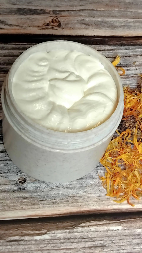 A jar of Forev'Herbs Eczema Cream for natural skincare and sensitive skin rests on a wooden surface, next to a small pile of dried yellow and orange flower petals.