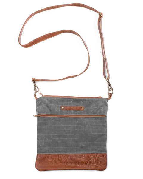 The Rogue Industries Ellis River Crossbody Bag features a stylish gray fabric body, brown leather accents on the bottom and strap, and a convenient front zipper pocket.