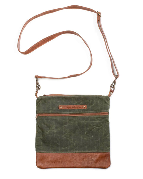 The Rogue Industries Ellis River Crossbody Bag is crafted from green waxed canvas with brown leather trim and strap, featuring a front zip pocket and a small leather patch with embossed text.