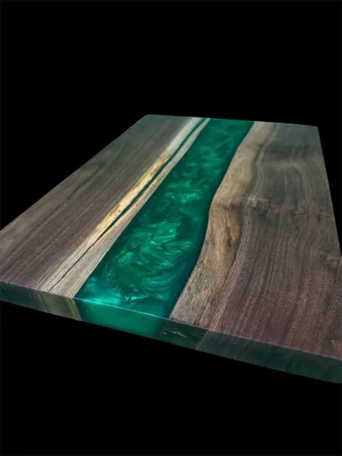 The Emerald Green Epoxy and Walnut Serving Board by B. James Design & Woodwork features a glossy emerald epoxy river through walnut, handcrafted in the USA, shown against a black background.