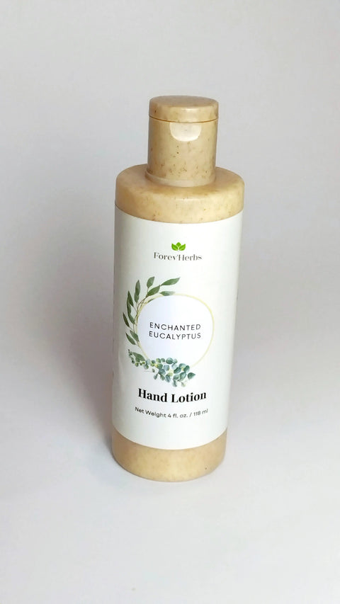 A beige bottle of Enchanted Eucalyptus Hand Lotion by Forev'Herbs, featuring a green leaf design and flip-top cap, is set against a plain white background.