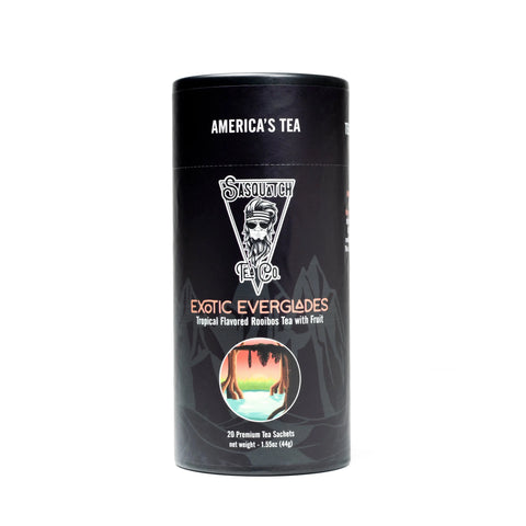 A black cylindrical Sasquatch Tea Co. container labeled Exotic Everglades (Rooibos Fruit Tea) features a swamp scene, notes caffeine-free rooibos with exotic fruit, inspired by Everglades National Park, and contains 20 premium sachets.