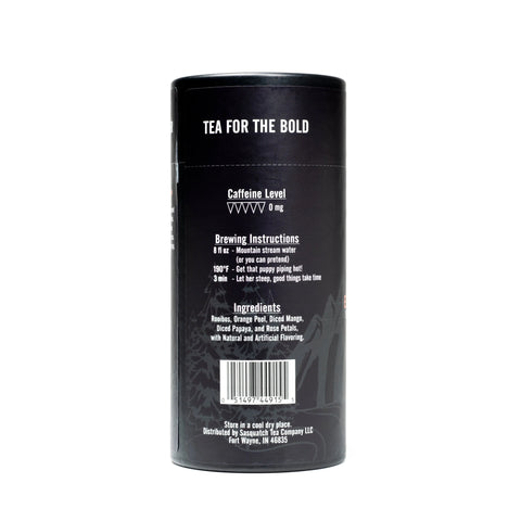 A black cylindrical Sasquatch Tea Co container labeled “Exotic Everglades (Rooibos Fruit Tea)” features bold white text, barcode, brewing instructions, ingredients, and caffeine level. Inspired by Everglades National Park; caffeine-free.