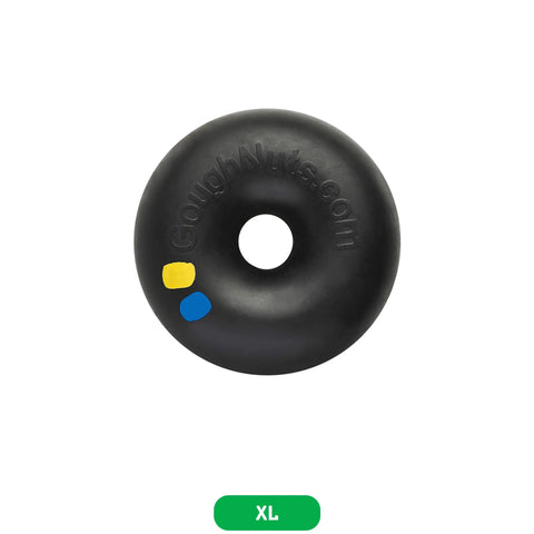 The Goughnuts XL Ring, a black rubber donut-shaped dog toy with yellow and blue dots and GoughNuts.com embossed, sits on a white background with a green XL label—built for aggressive chewers over 100 pounds.