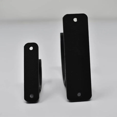 Two black, matte FRESHe Horizontal Fishing Rod Holders by Chatelet Manufacturing stand upright on a white surface. Both L-shaped brackets have two mounting holes; the left holder is smaller than the right, making them ideal for fishing rod storage.