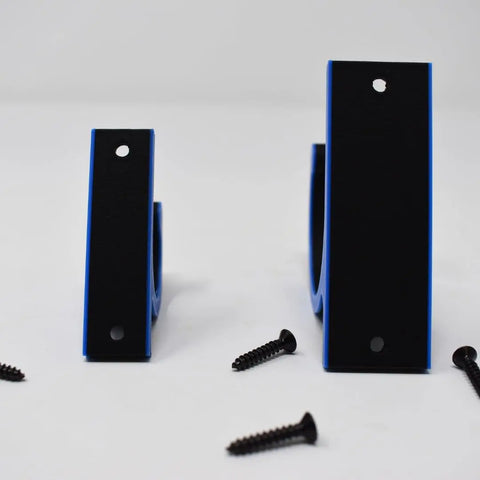 Two FRESHe Horizontal Fishing Rod Holders by Chatelet Manufacturing, black and blue U-shaped brackets in two sizes with mounting holes, stand upright on a white surface. Four black screws are scattered nearby—ideal for fishing rod storage.