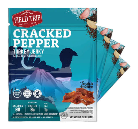 A pack of Field Trip Cracked Pepper Turkey Jerky 2.2oz (4ct) features a mountain scene and showcases cracked pepper, garlic, and jerky pieces. Packaging highlights: gluten free, no added hormones, preservatives, or artificial ingredients.