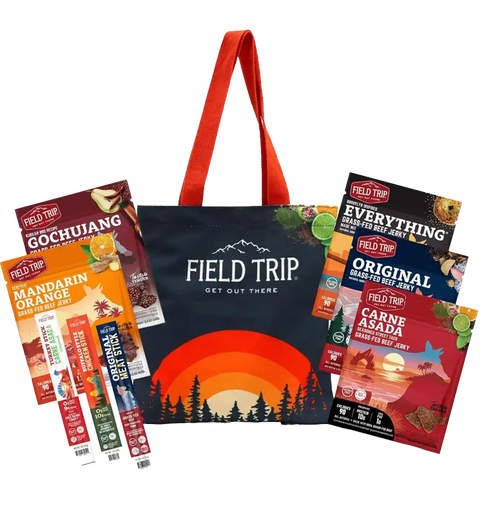 The Field Trip Gift Bag by Field Trip features a mountain and forest tote surrounded by a tasty set of jerky in Gochujang, Everything, Carne Asada flavors, plus three grass-fed meat sticks.