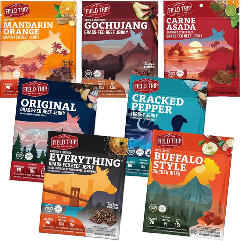 Seven Field Trip Variety 7ct Jerky (Beef) packages, made from grass-fed beef with no preservatives, are arranged overlapping in flavors including Mandarin Orange, Gochujang, Carne Asada, Original, Cracked Pepper, Everything, and Buffalo Style.