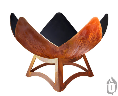 The Fire Flower Fire Bowl With Hollow Base by Ohio Flame features a rusted, bowl-shaped metal design with four upward-curving panels and a sturdy base; its black interior contrasts with the weathered exterior. Made in the USA.