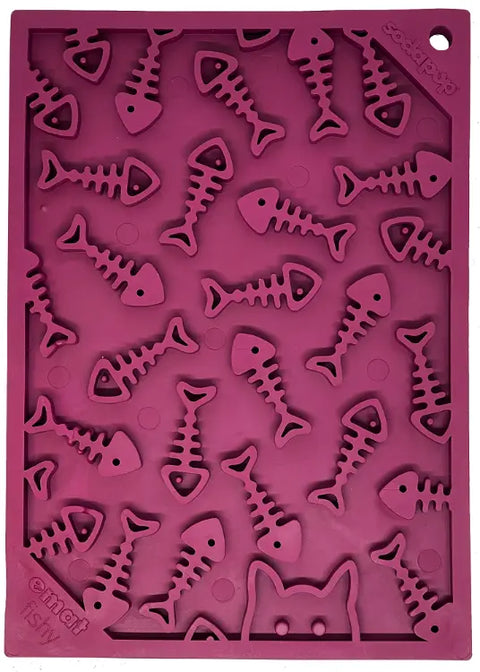 The SodaPup Fishy Design EMat Enrichment Lick Mat - Small is a purple silicone mat featuring fish bone shapes and a cat face outline, perfect for calming dogs and cats during treat time.