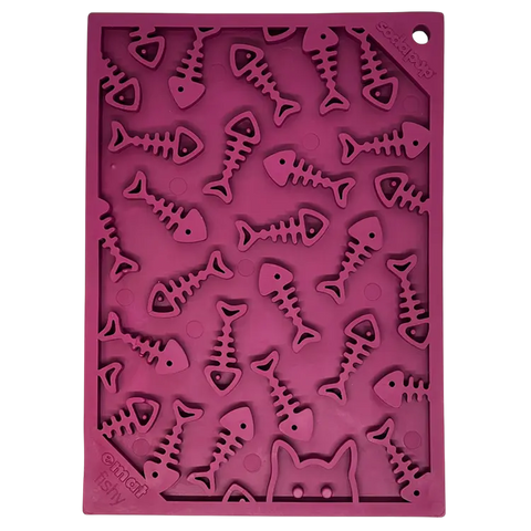 The SodaPup Fishy Design Enrichment Lick Mat (Small, 8x6 in) is a purple silicone feeder with fish skeleton and cat face cutouts, perfect for slow feeding or treats to stimulate cats and dogs. Made in the USA.