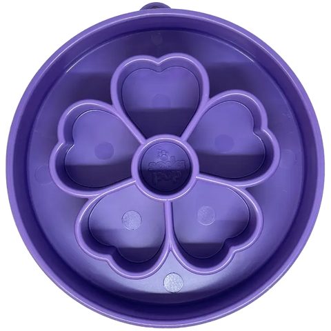 The SodaPup Flower Design EBowl Enrichment Slow Feeder Bowl for Dogs is a round, purple silicone bowl with a flower-shaped center that promotes slow eating by dividing food into sections.