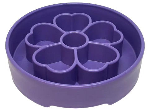 The SodaPup Flower Design EBowl Enrichment Slow Feeder Bowl for Dogs is a purple, round bowl with raised interior dividers in a flower shape, designed to slow eating and enrich mealtime for pets.