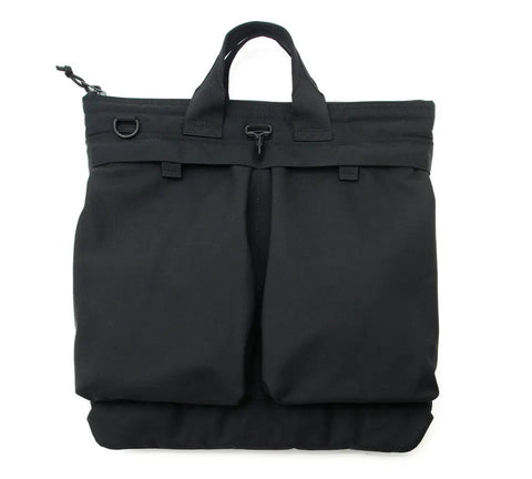 The MIS Flyers Helmet Bag With Alice Strap - Black is made from sturdy, water-resistant Cordura Nylon. It features two handles, two large front pockets, a metal clasp, and a small side loop. Photographed against a white background.