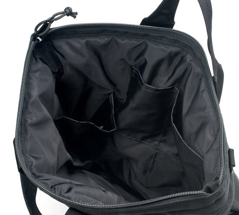 A top-down view of the unzipped and open MIS Flyers Helmet Bag With Alice Strap - Black, made from Cordura Nylon, highlighting its multiple inner pockets and compartments.