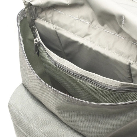 Close-up of the MIS Backpack - Foliage, made in USA from Cordura nylon, showing its textured fabric, multiple compartments including a mesh pocket, padded laptop holder, and a large zippered section.
