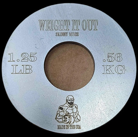 A round Fractional Solid Steel Mini Olympic Weight Plate by Weight It Out, labeled 1.25 LB (.56 KG) with a muscular figure, MADE IN THE USA, and a center hole sized to fit an Olympic bar for gradual weight increases.