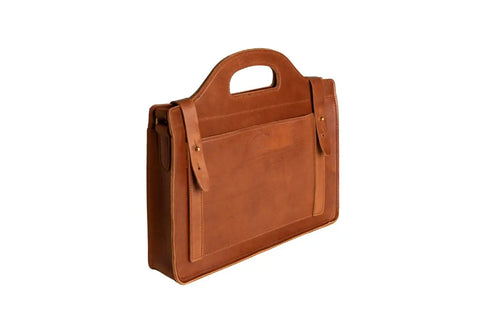 The Urban Southern Franklin Satchel is a brown leather laptop bag with a built-in handle, front pocket, and two side straps, shown on a white background.