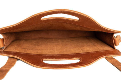 The Urban Southern Franklin Satchel is a brown leather professional bag featuring a suede interior, spacious main compartment, and top flap handle cutouts—ideal as a stylish laptop bag.