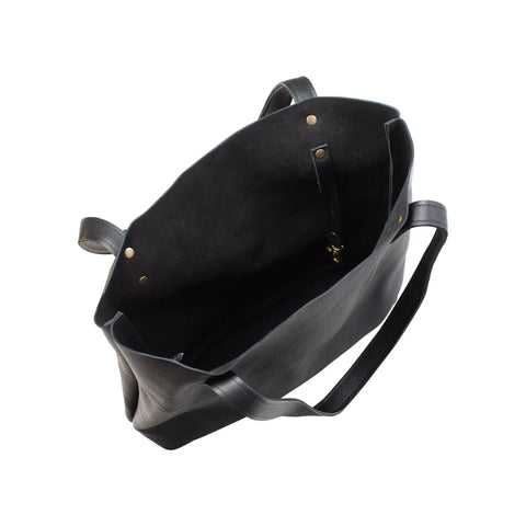 The Fore Street Tote Bag by Rogue Industries is a Maine-crafted black full-grain leather tote with long handles, a spacious interior, small pocket, and gold rivet details—shown here from above.