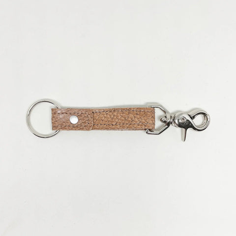 The Rogue Industries Leather Key Chain features a light brown textured full grain leather strap with a silver keyring and lobster clasp, shown on a white background.