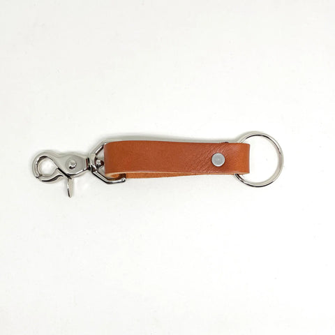 The Rogue Industries Leather Key Chain, crafted from brown full-grain leather with a silver key ring and clasp, is made in Maine and shown on a white background.